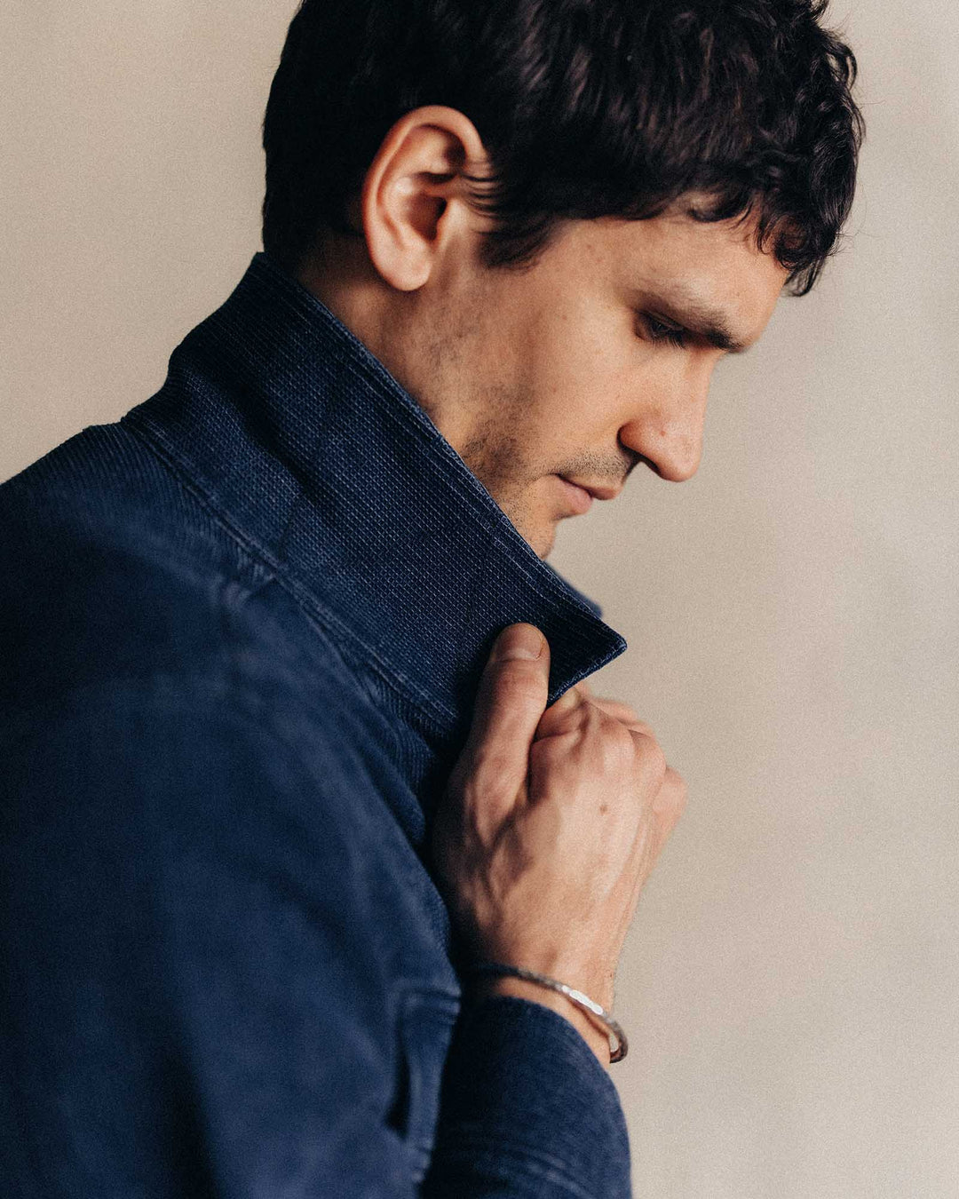 man wearing jean jacket with the collar up.