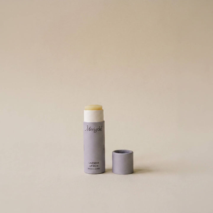 Lip balm with a light purple container on a beige background