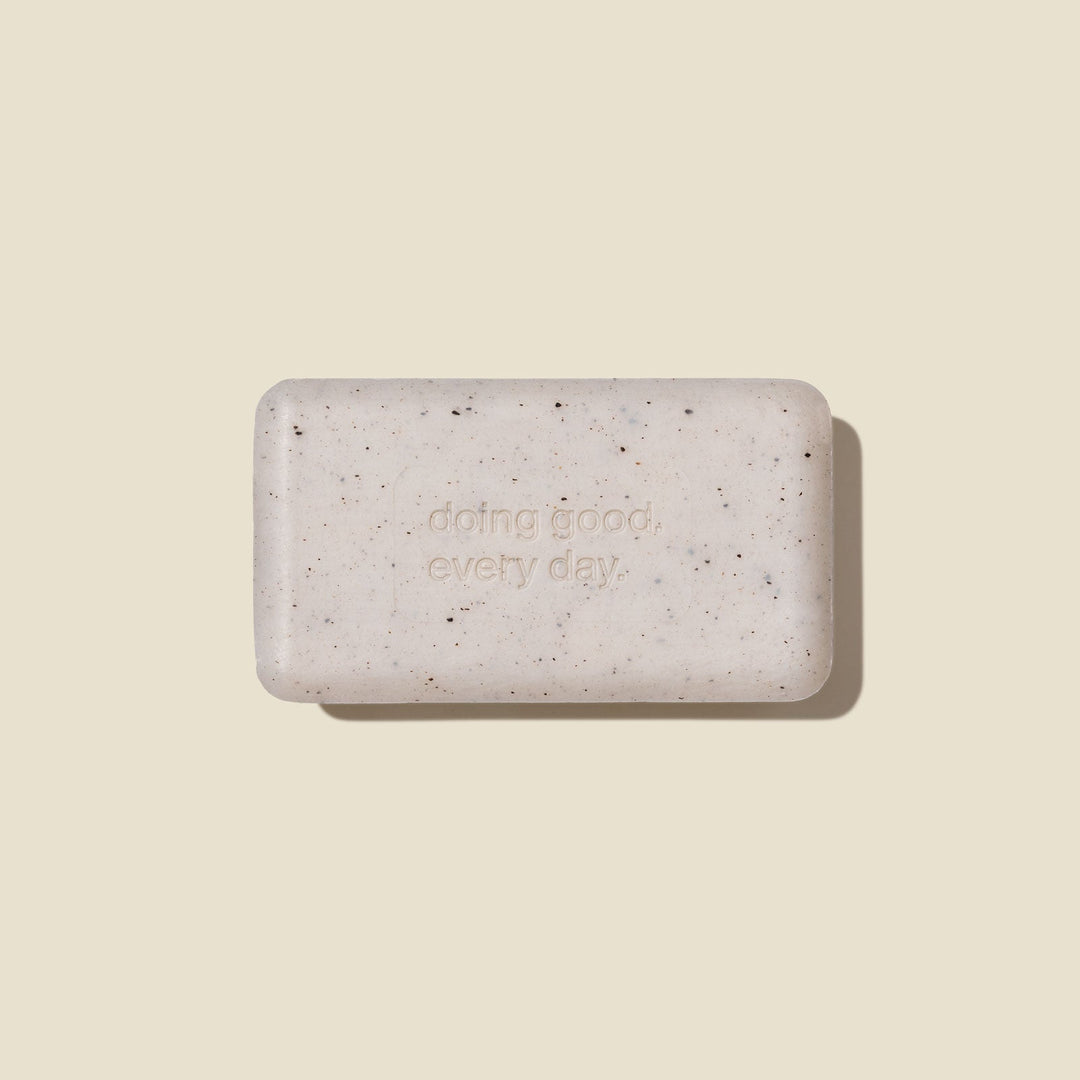 Speckled gray soap bar with 'doing good, every day' text on a beige background