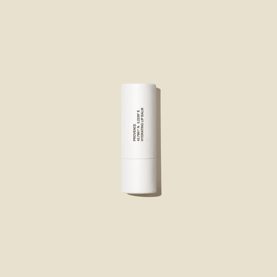 Evolve togther White lip balm tube on a beige background