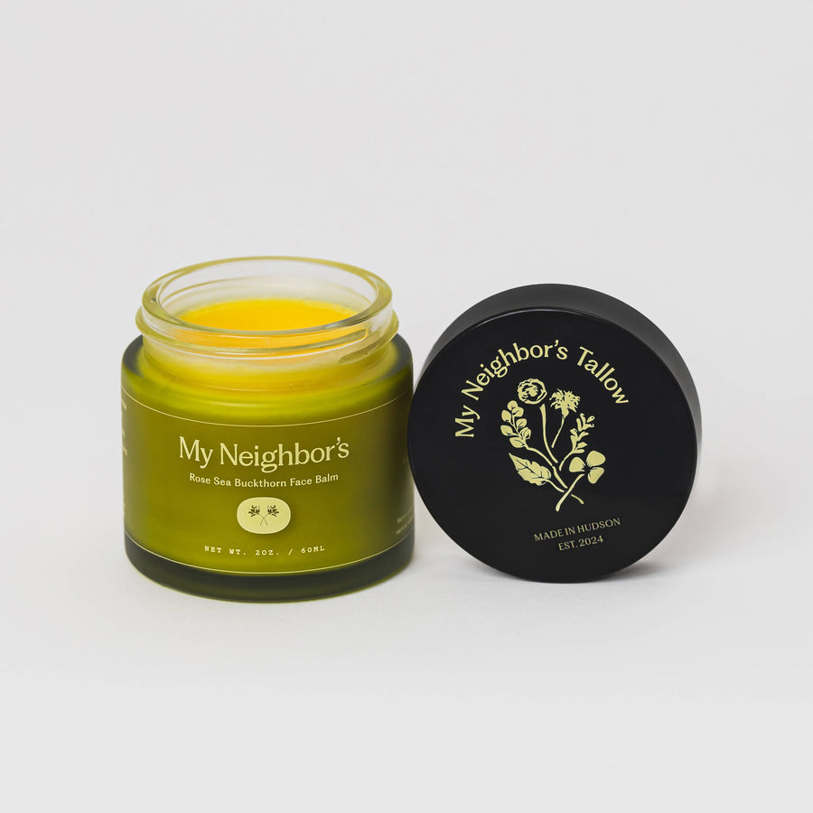 Jar of 'My Neighbor's Tallow' face balm with lid on a white background