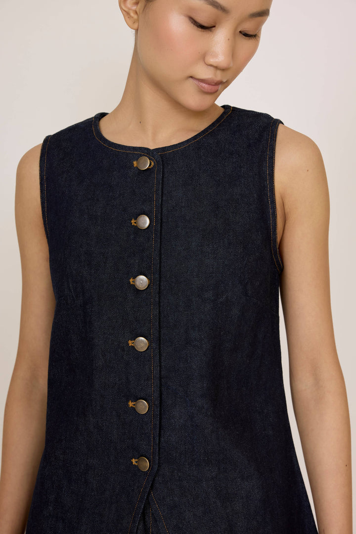 Woman wearing a Laude Longline Vest in Dark Indigo over a plain background