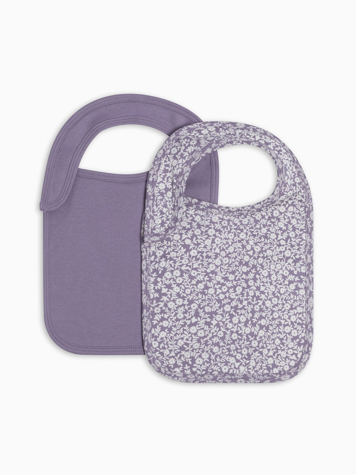 Two baby bibs in a soft lavender-purple color, one solid and one with a small white floral print, shown on a clean white background.
