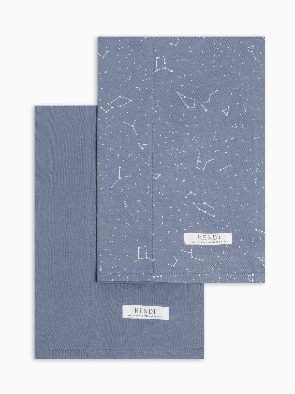 Two colored organics burp cloths in bluen and constellation on a white background.
