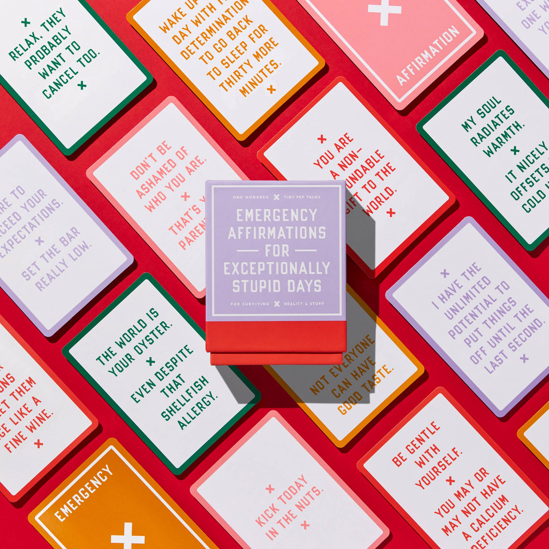 Collection of affirmation cards with a central purple box titled 'Emergency Affirmations for Exceptionally Stupid Days' on a red background.