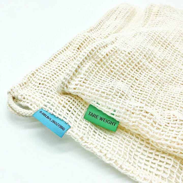 Mesh produce bag with two labels on a white background