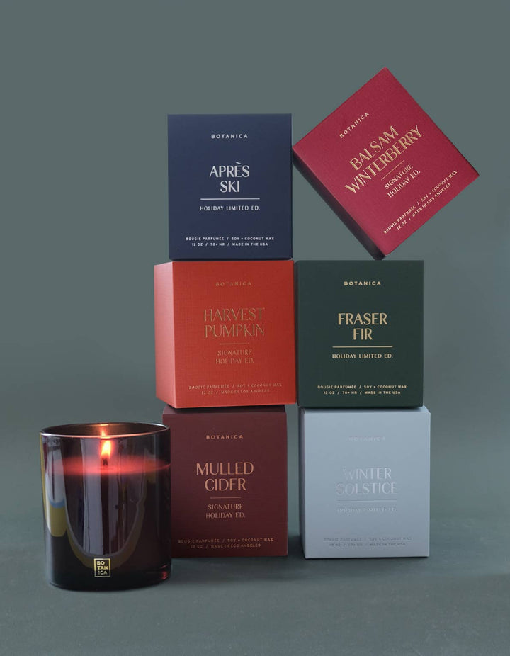 Collection of Botanica candles and boxes on a gray background