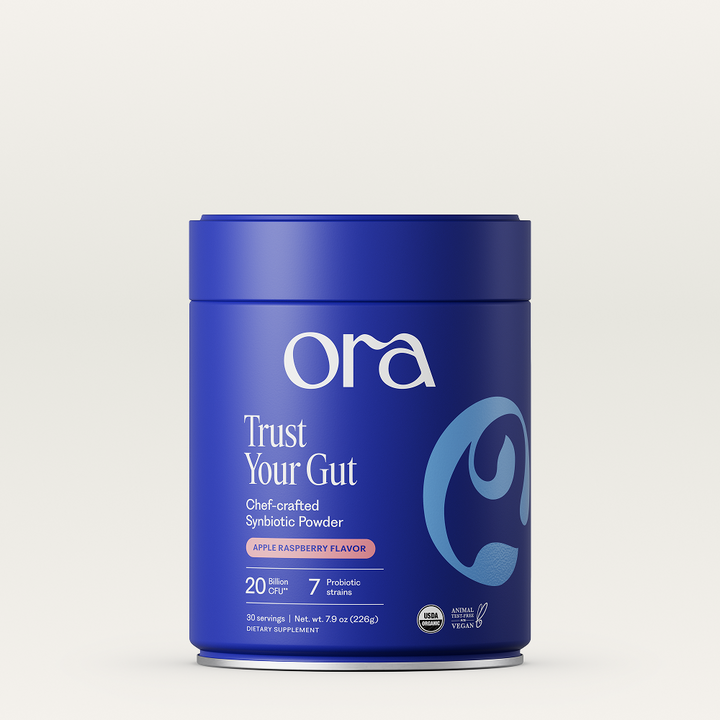 Blue container of Ora Trust Your Gut powder on a light gray background