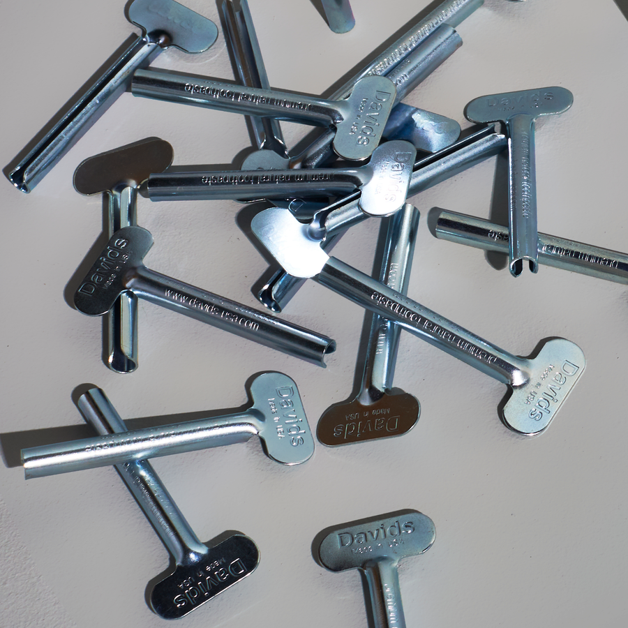 Collection of metal tube keys with 'David' branding on a light background