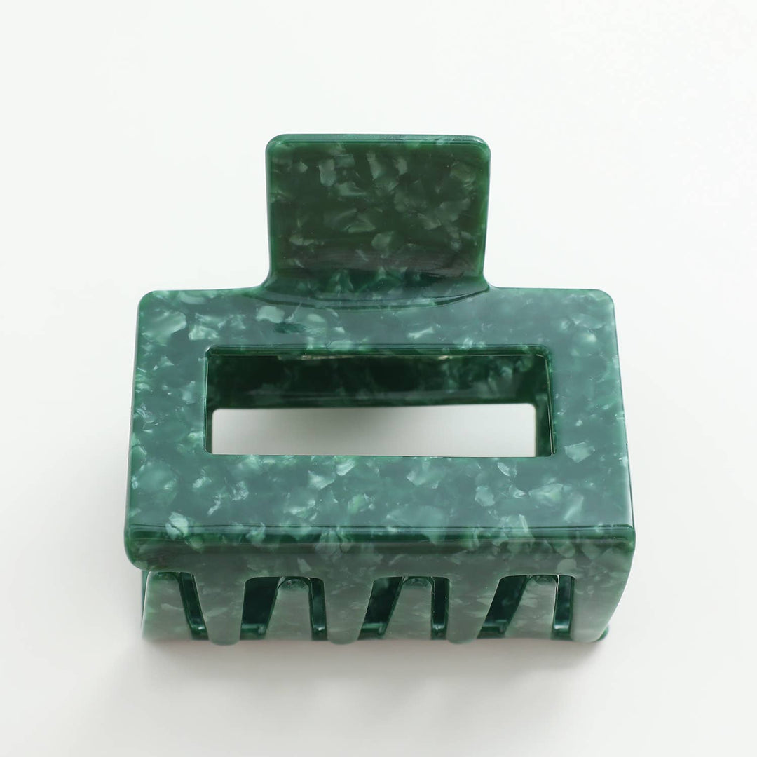 Green marble-patterned hair clip on a white background