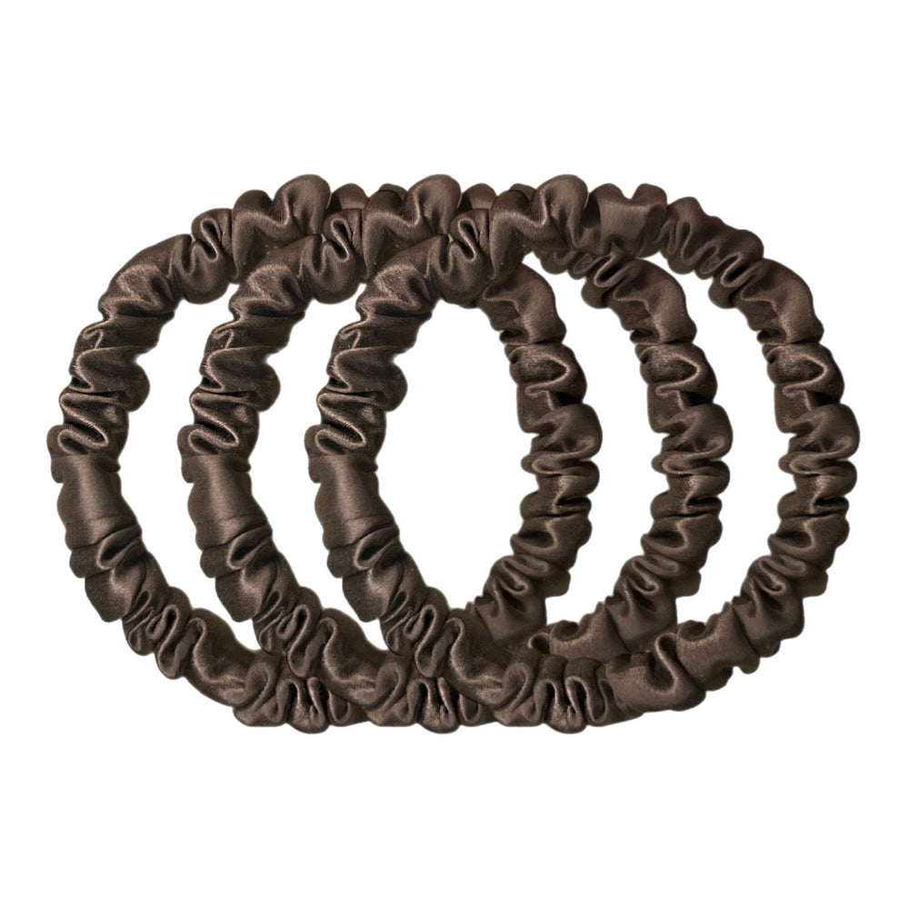 Set of three brown silk hair scrunchies on a white background