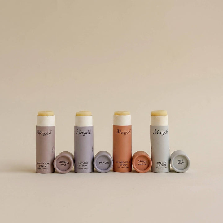 Set of lip balms with visible brand name on a beige background