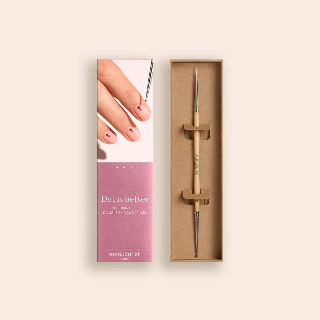 Manicure dotting tool with packaging on a beige background