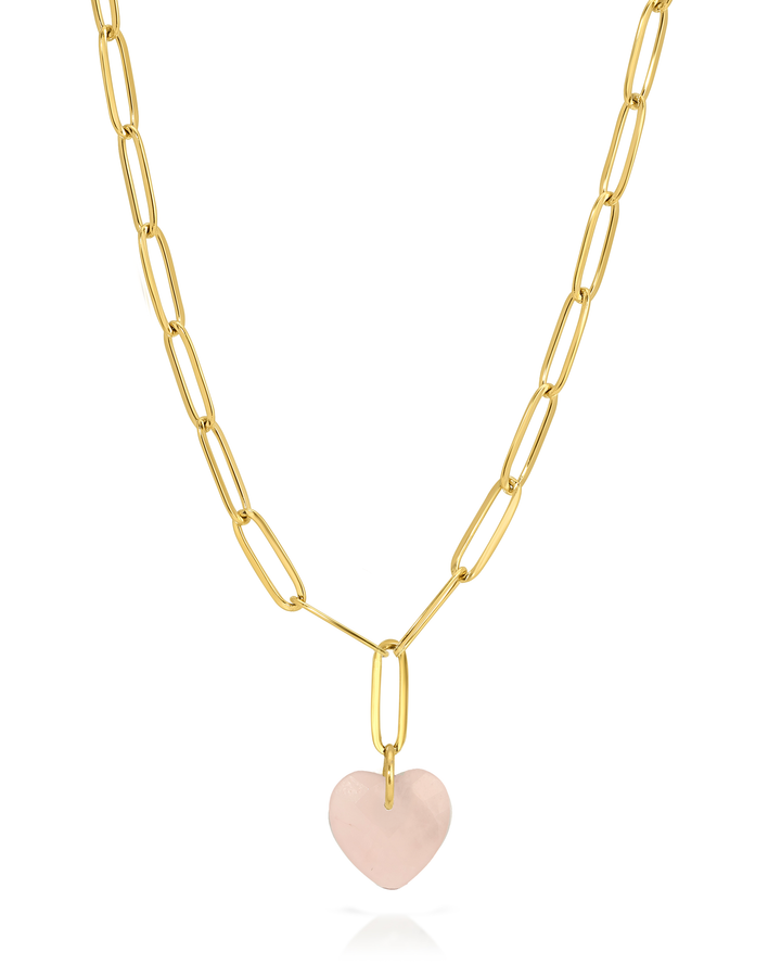 Gold chain necklace with a pink heart pendant on a white background