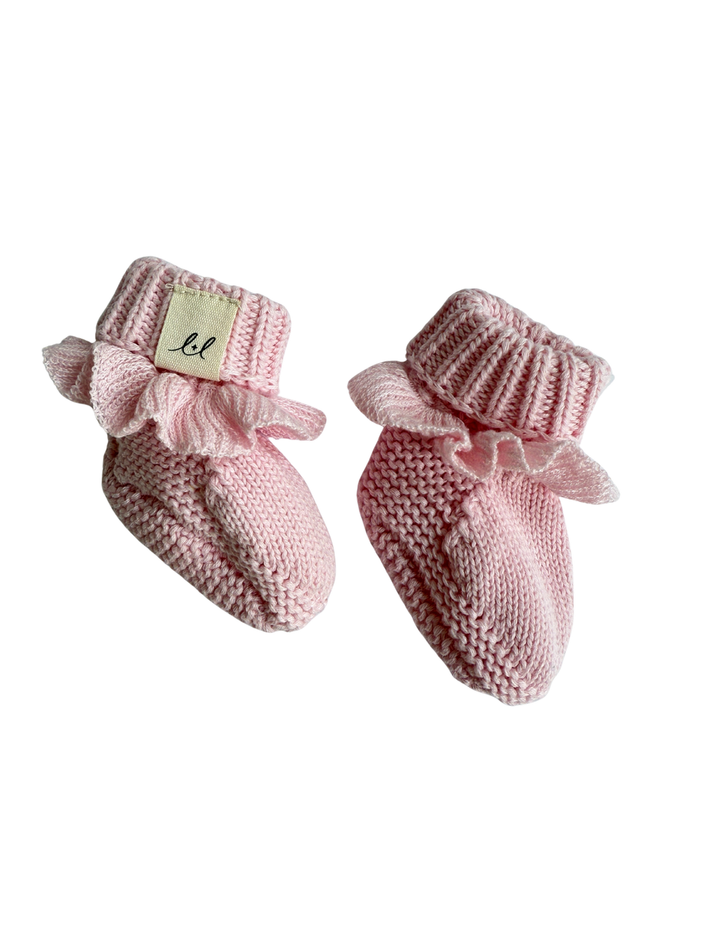 Pair of pink knitted baby booties with ribbed texture on a white background