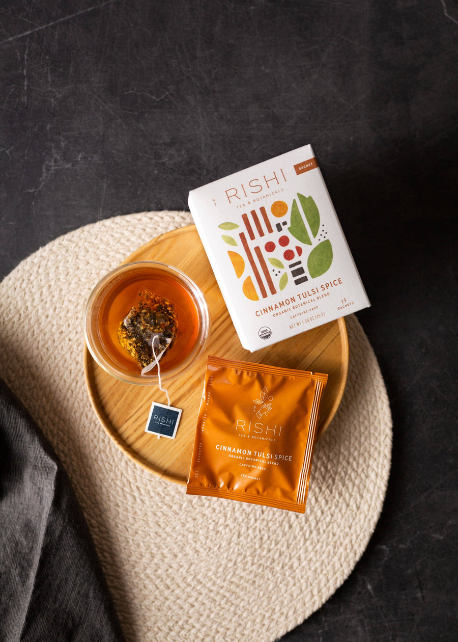Rishi tea packaging with a cup of tea on a textured surface