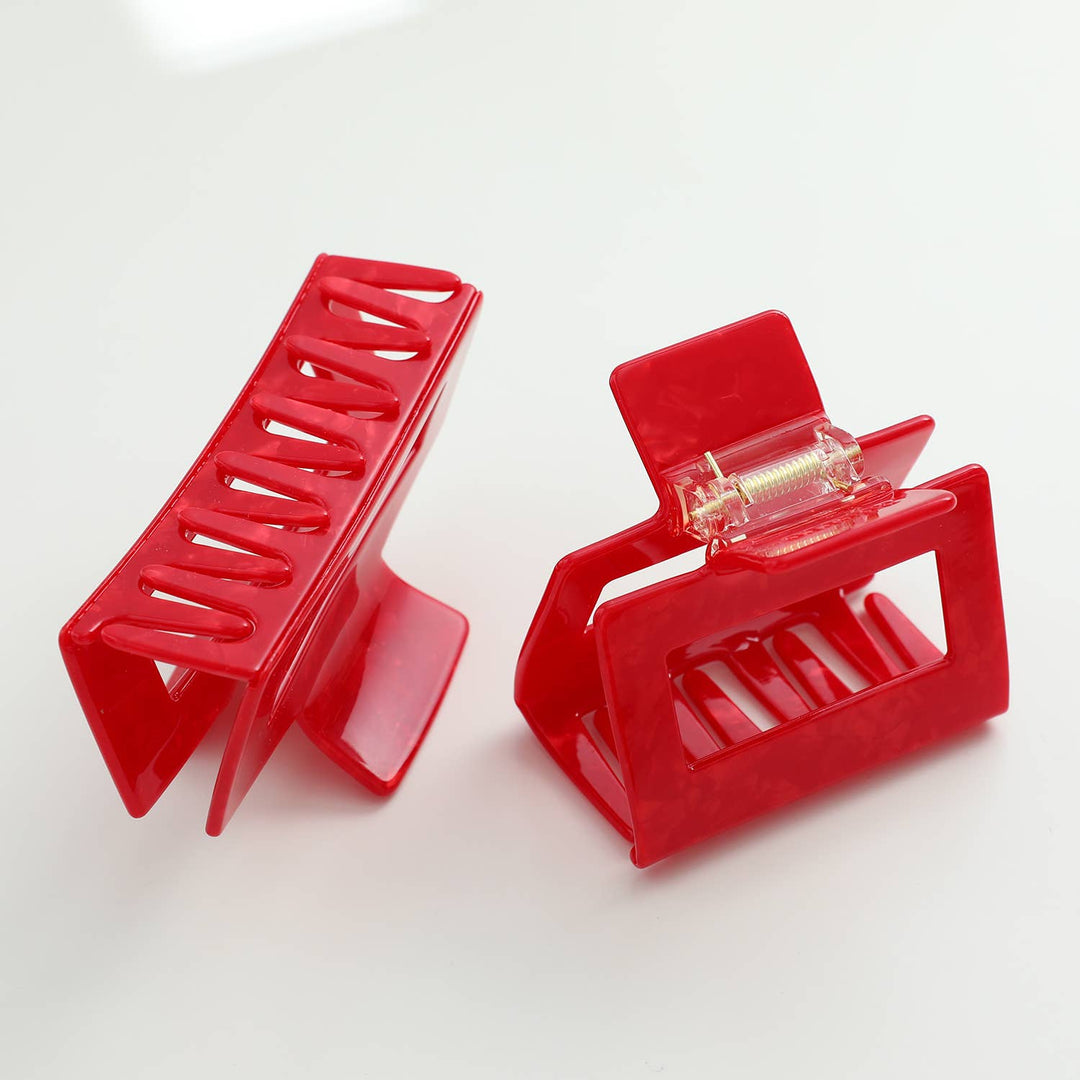 Two red hair clips on a white background