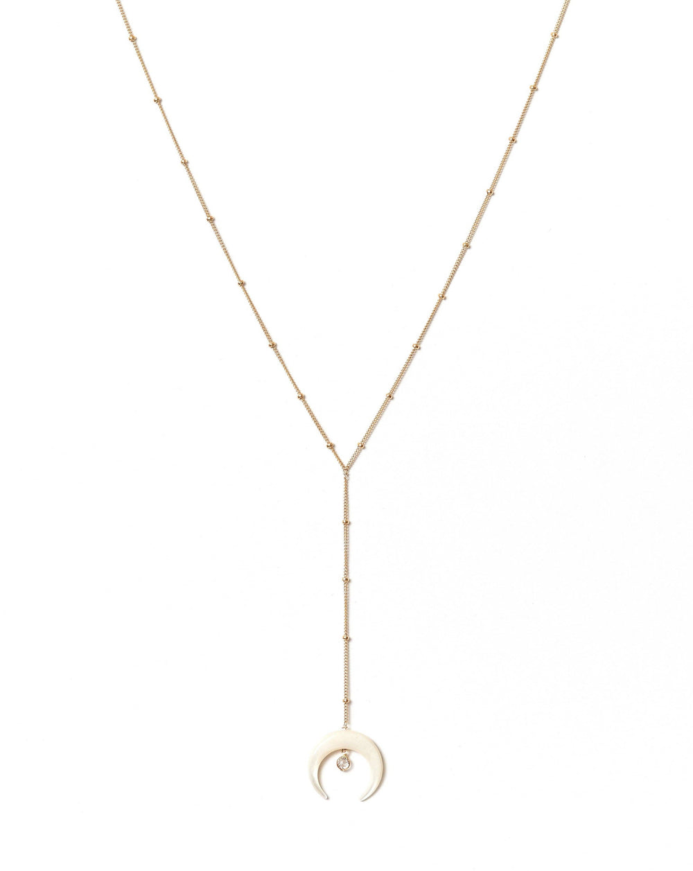 Gold necklace with a crescent moon pendant on a white background