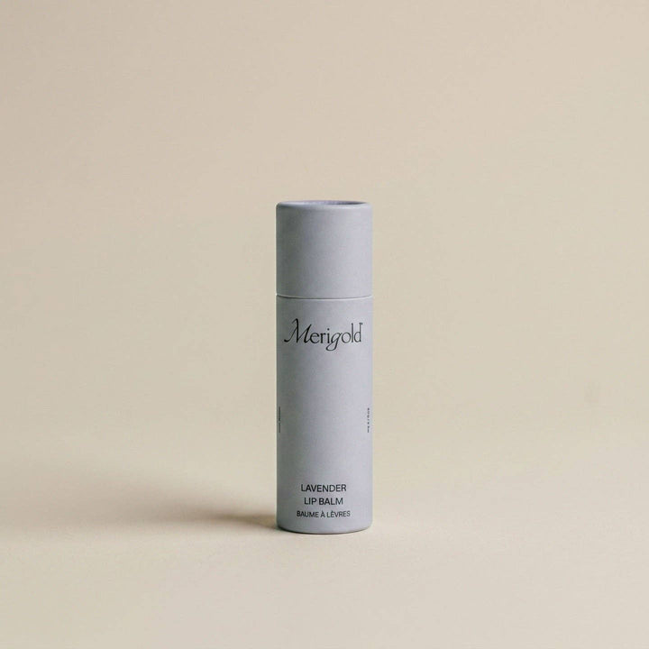 Lavender lip balm in a light purple cylindrical container on a beige background