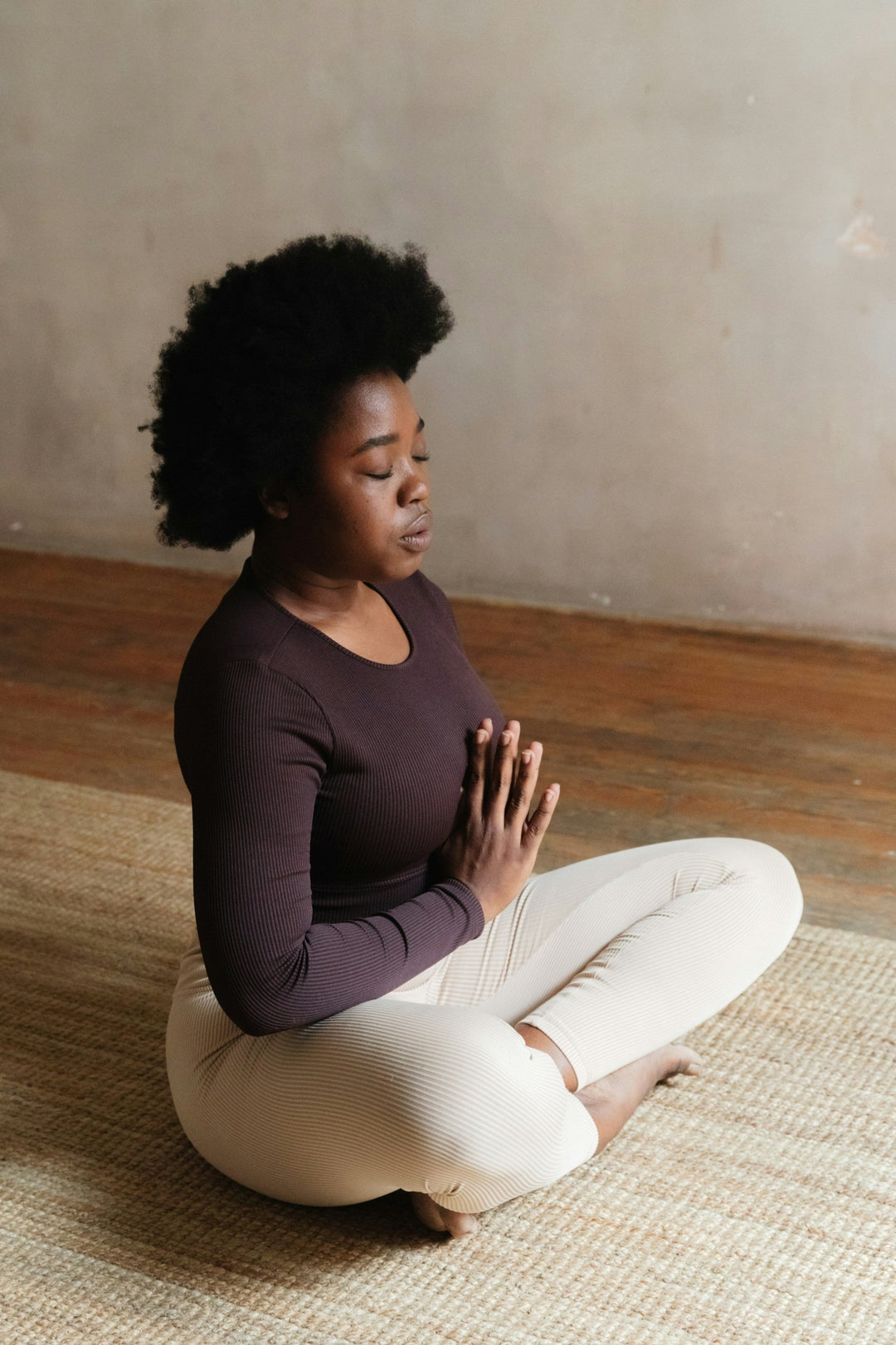 A woman practicing meditation as a part of her holistic health routine