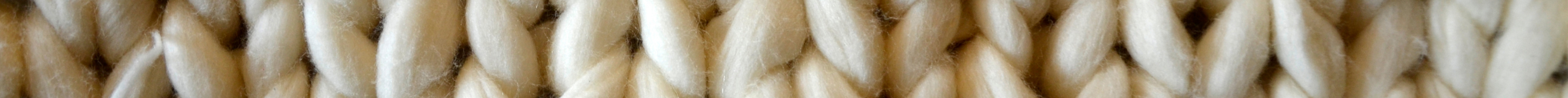 Close-up of beige knitted yarn texture