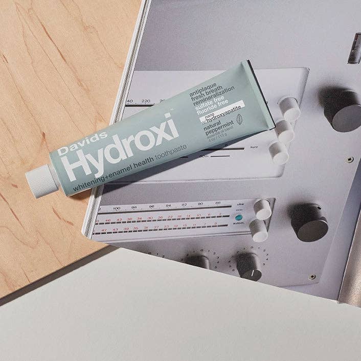 Tube of David's Hydroxi toothpaste on a metallic surface
