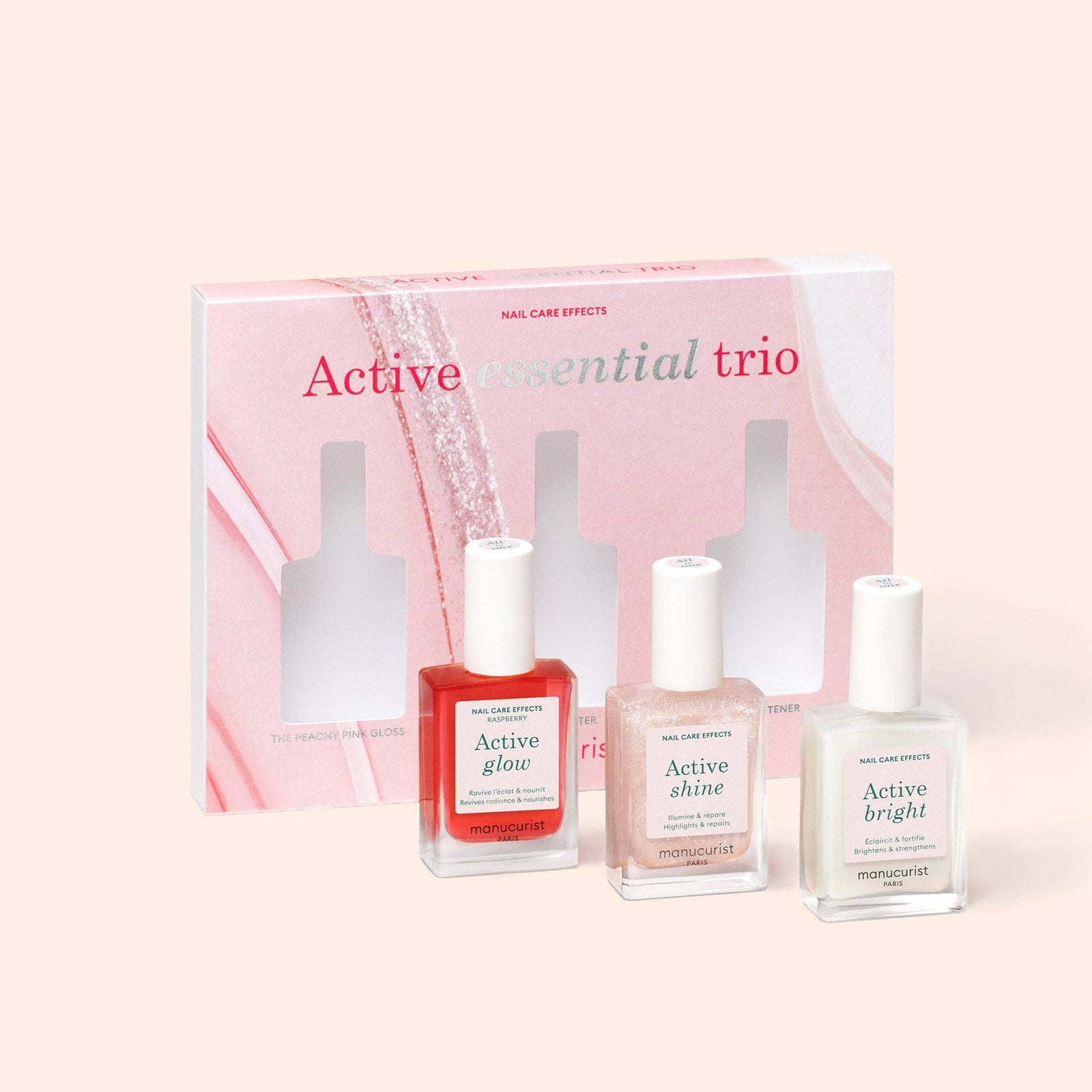 Three nail polish bottles with a packaging box labeled 'Active Essential Trio' on a light pink background.