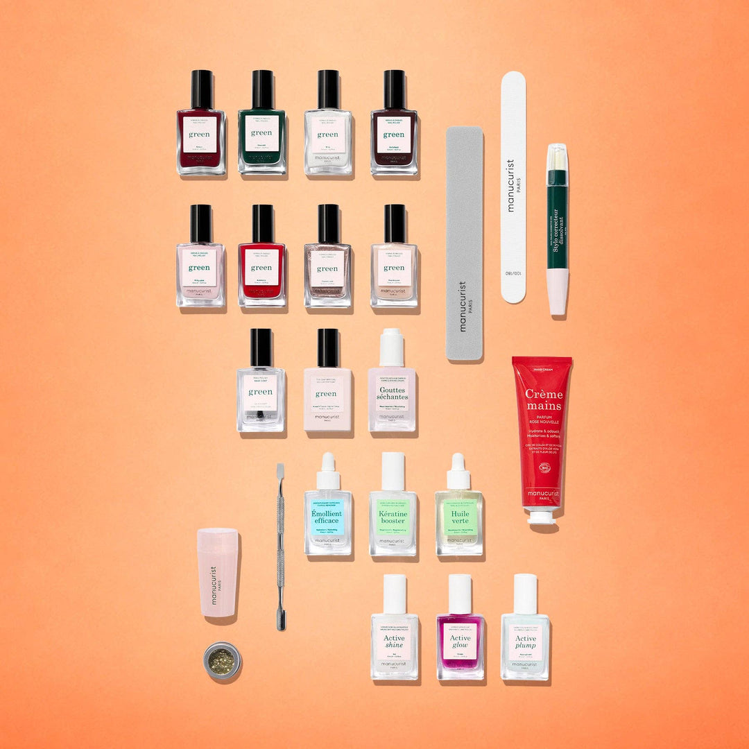 An overhead flat-lay arrangement of all included items in the Manucurist advent calendar kit. 