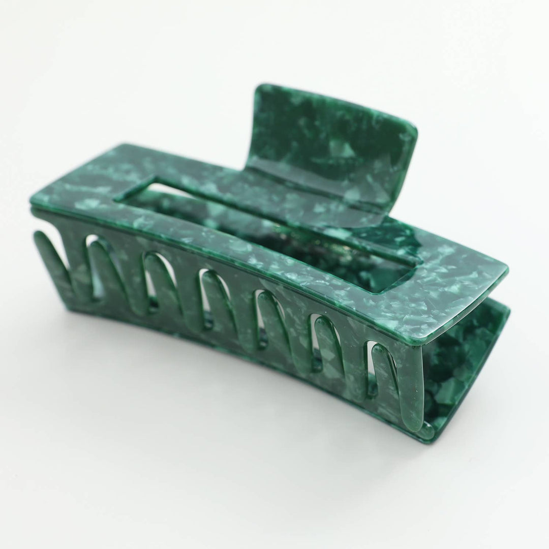 Green marble-patterned hair clip on a white background