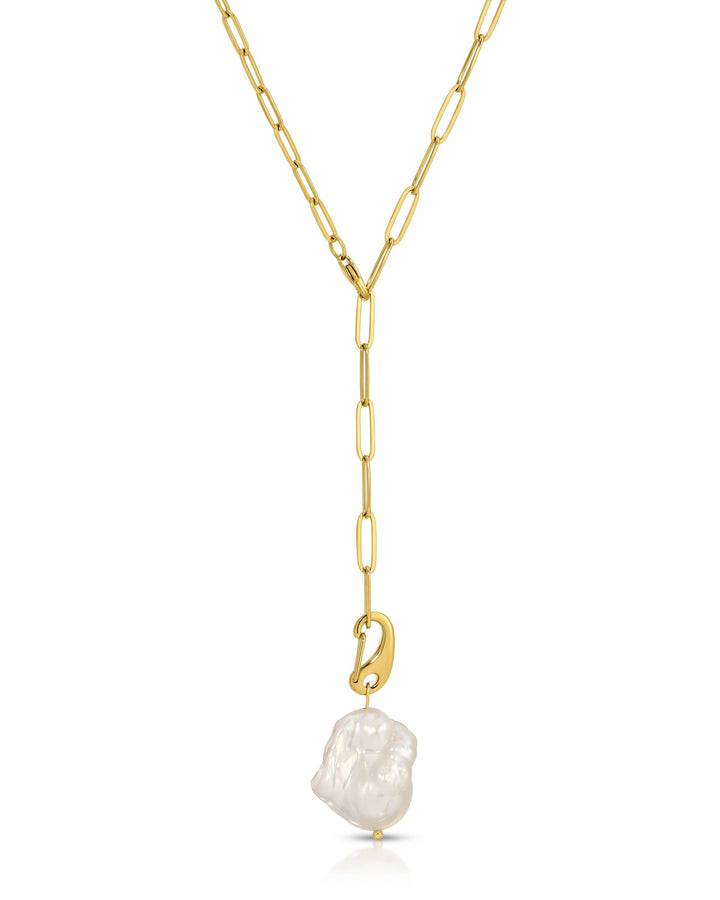 Gold necklace with a white pearl pendant on a white background