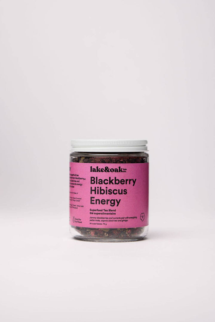 Jar of blackberry hibiscus energy tea with pink label on a white background