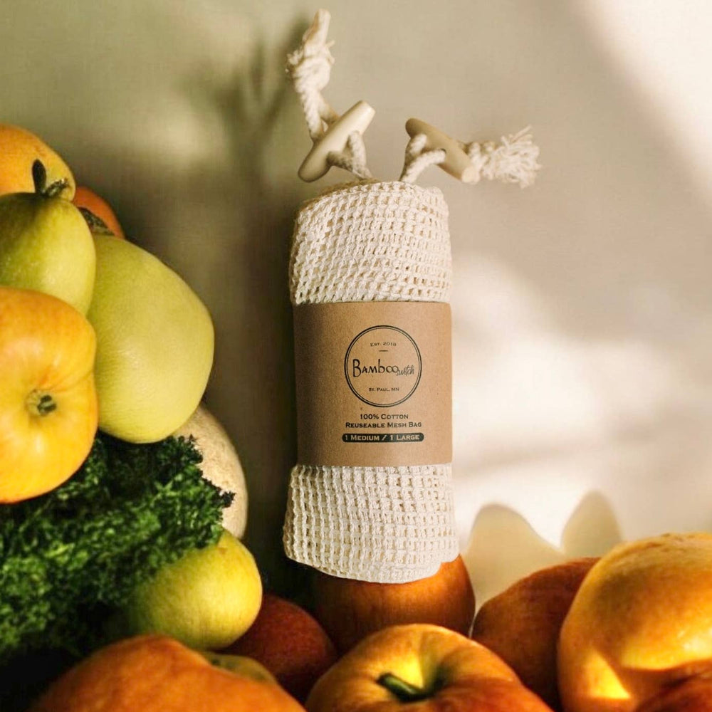Organic Cotton mesh produce bag with packaging surrounded by apples and foliage