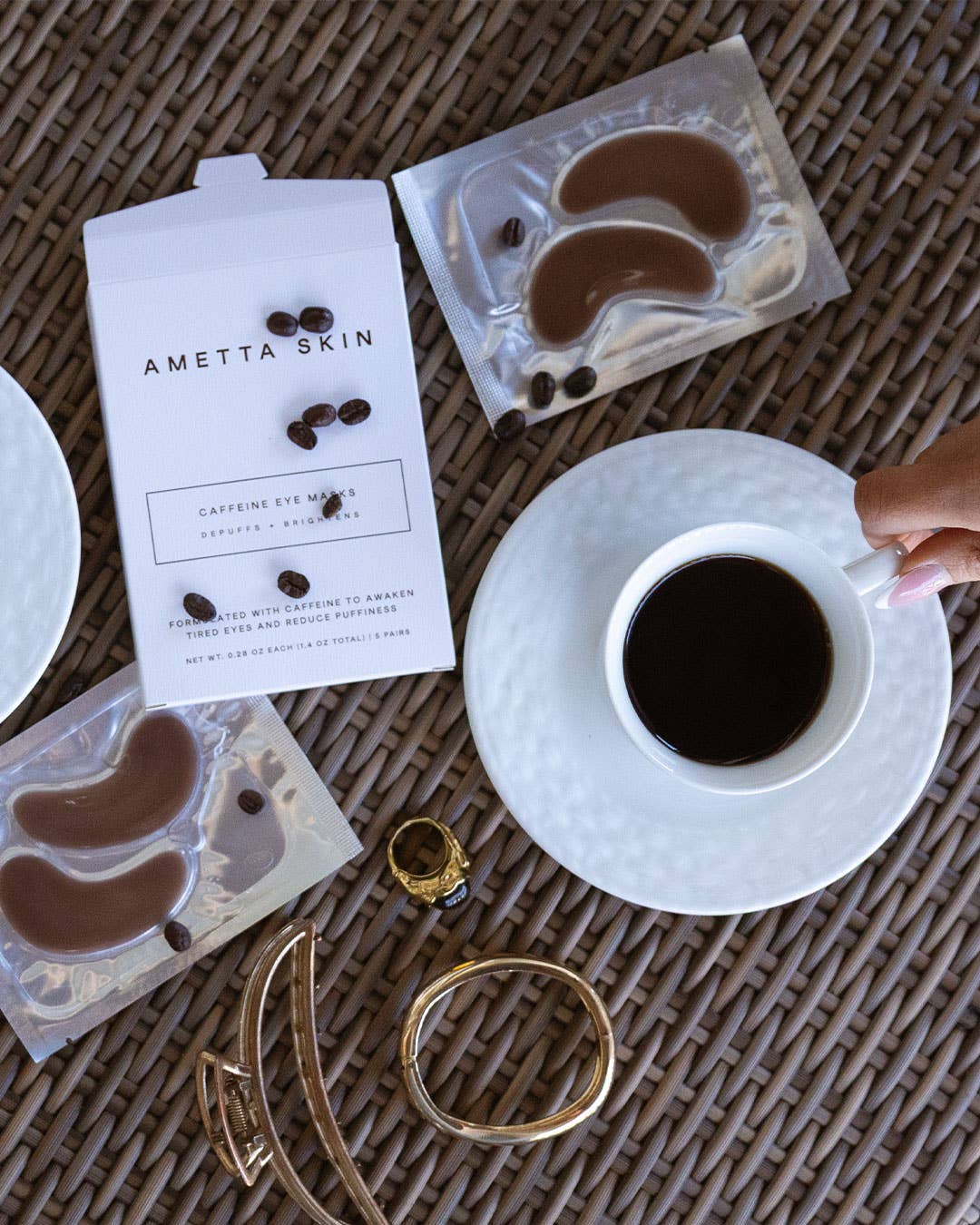 Ametta Skin eye masks with a cup of coffee on a textured surface