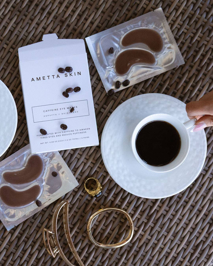 Ametta Skin eye masks with a cup of coffee on a textured surface