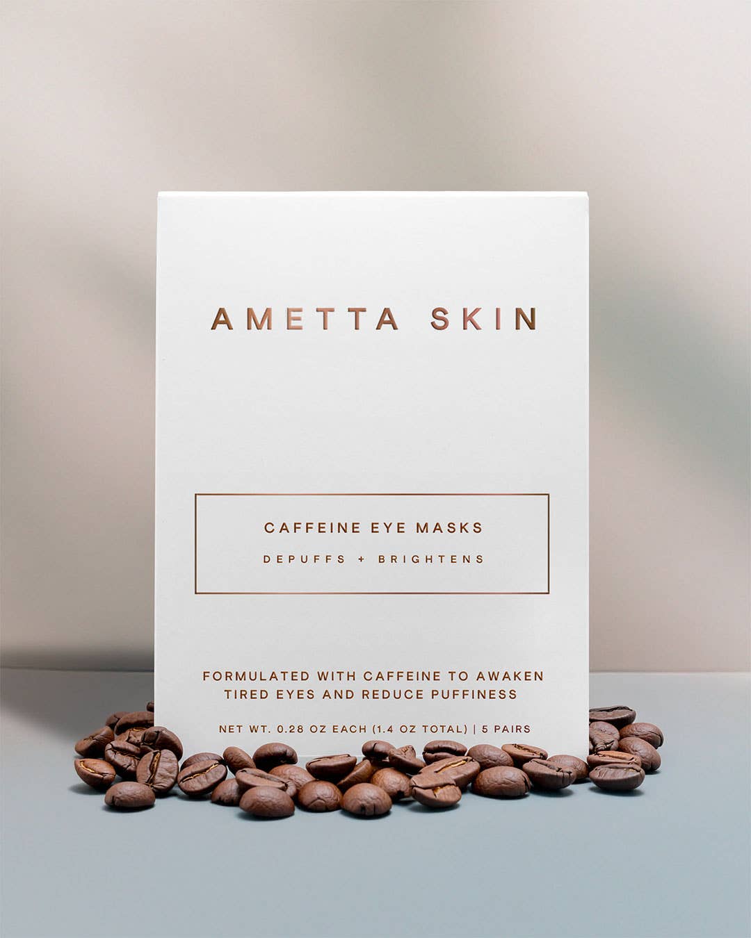 Ametta Skin caffeine eye masks packaging with coffee beans on a neutral background