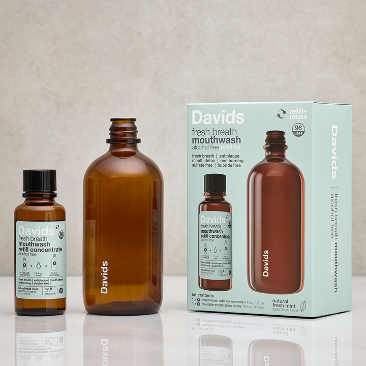 Davids mouthwash bottles and packaging on a reflective surface with a neutral background