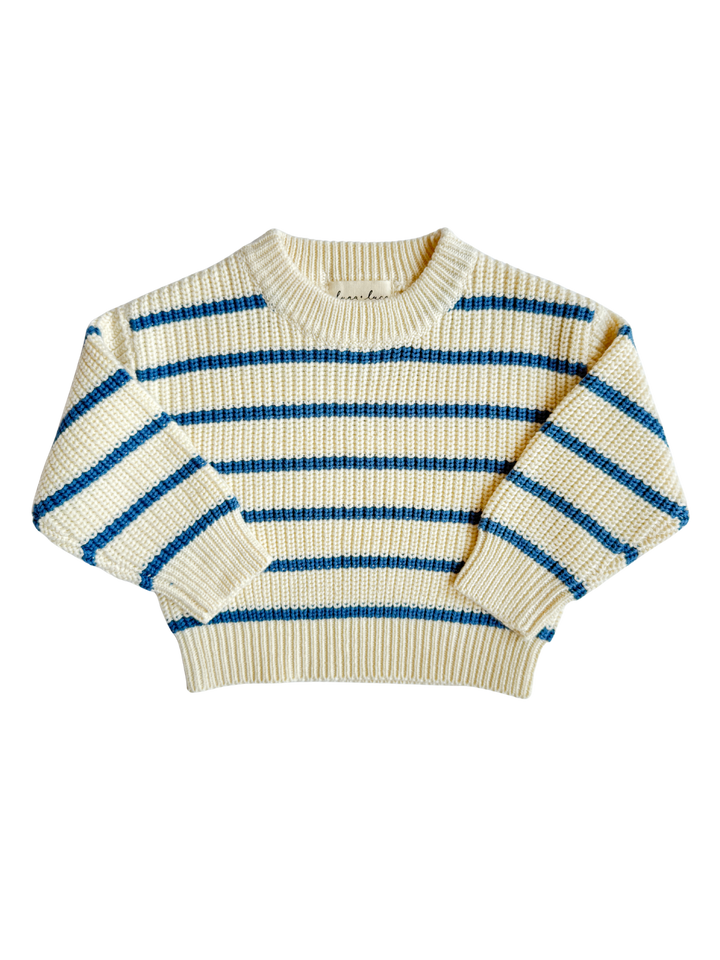 Striped sweater with blue and beige pattern on a white background