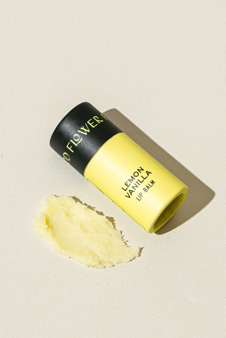 A yellow lip balm tube labeled &