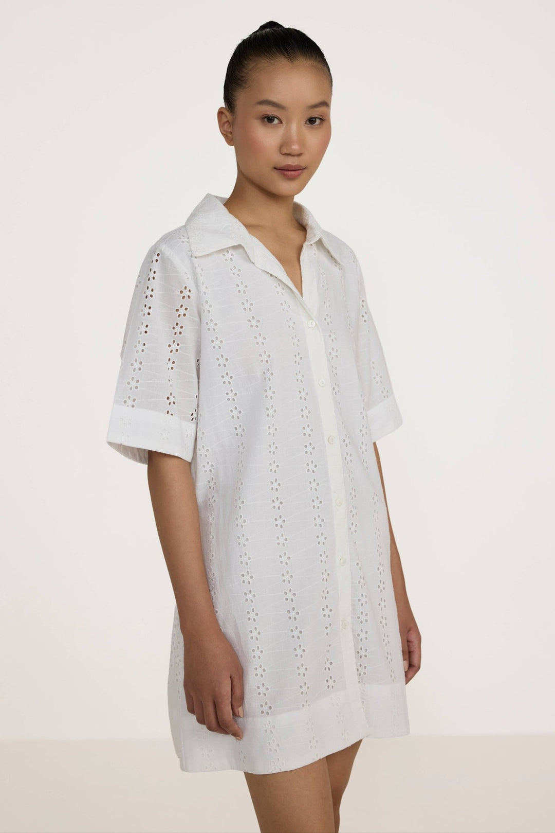 Woman wearing a Laude the Label Classic Shirt Dress in Ivory Lace on a white background