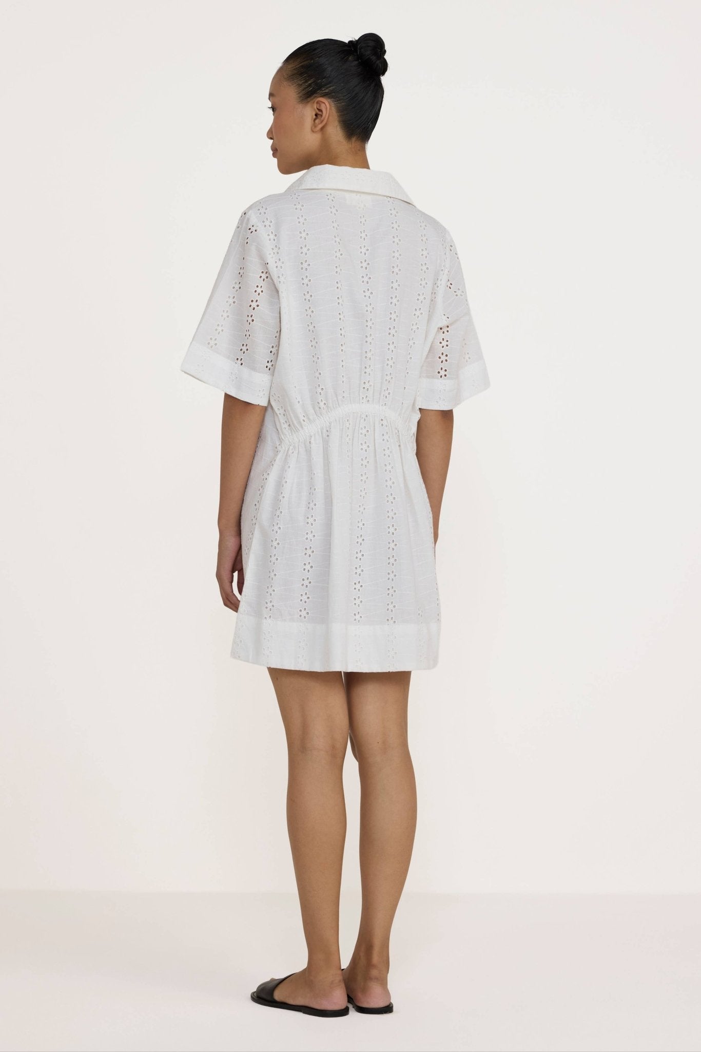 Woman wearing a Laude the Label Classic Shirt Dress in Ivory Lace on a white background
