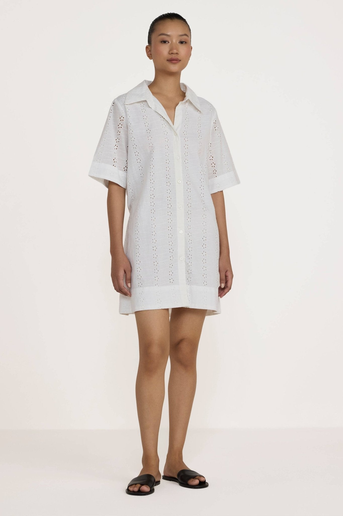 Woman wearing a Laude the Label Classic Shirt Dress in Ivory Lace on a white background