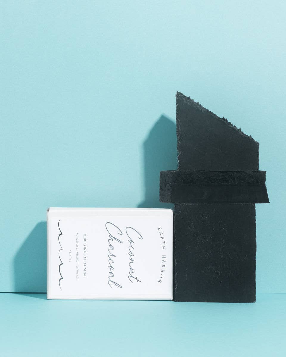 Earth Harbor coconut Charcoal Soap bar and packaging on a light blue background