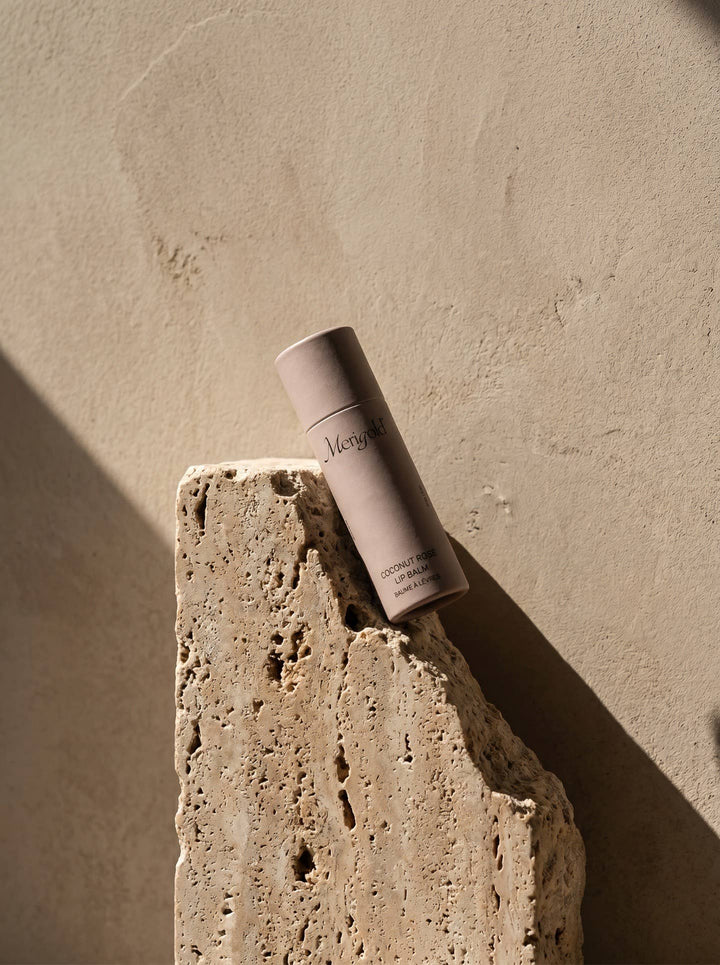 Lip Balm on a textured stone surface with a neutral background