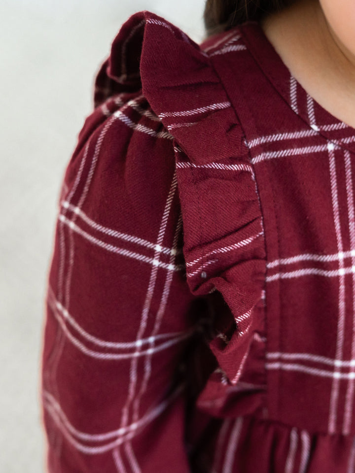 Close-up of a Celyn Flannel Ruffle Long Sleeve Dress.