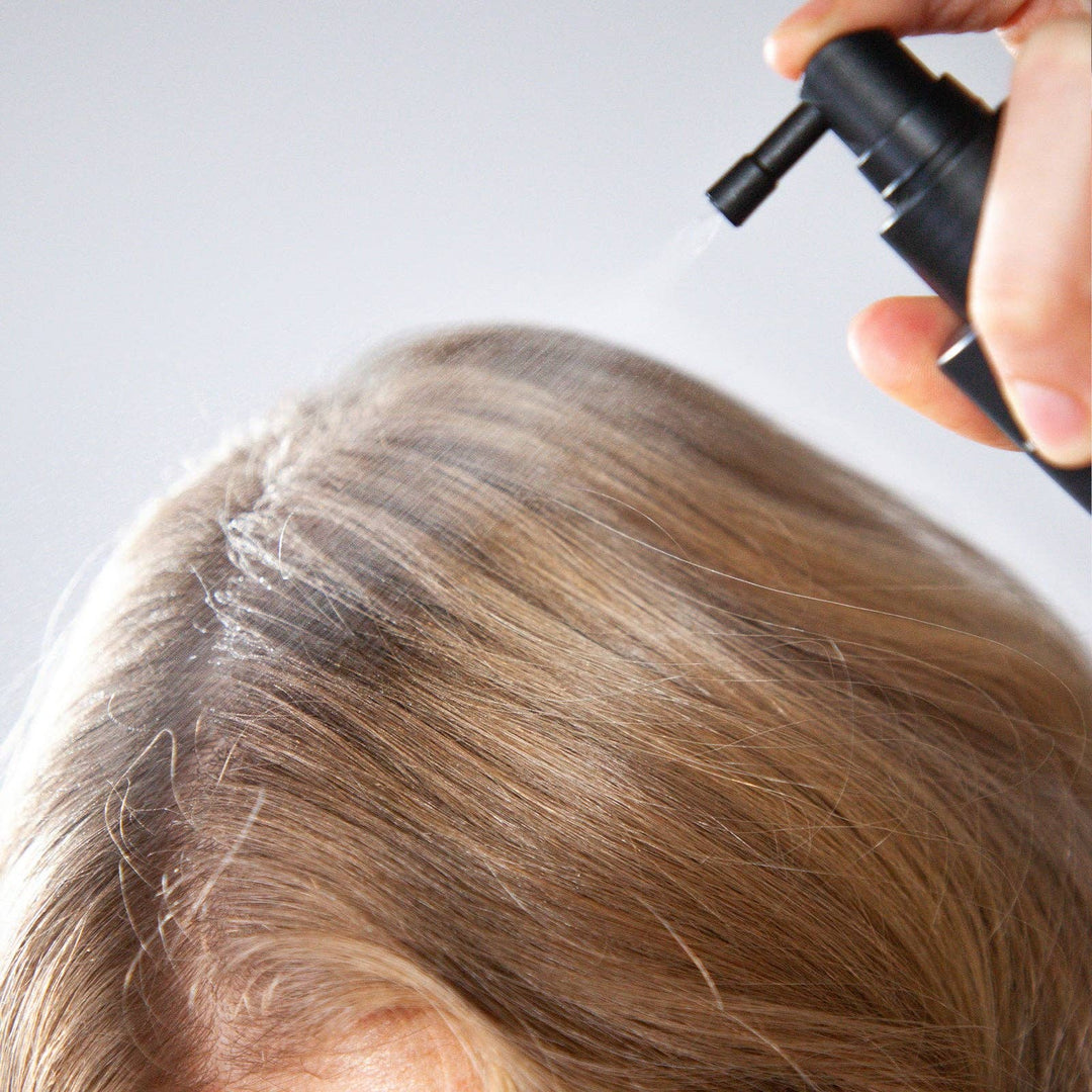 Person applying copper sequence to light colored hair.