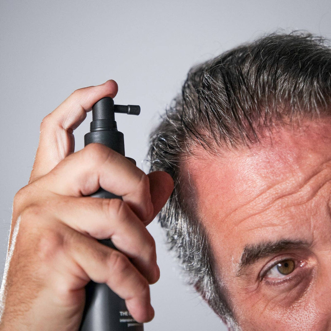 Person using Copper Sequence on their hair against a gray background