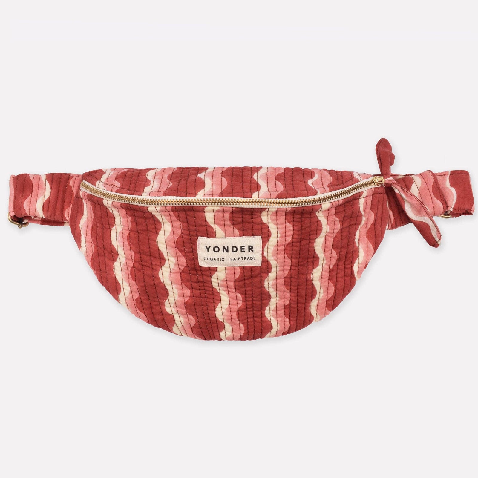 Red and white striped fanny pack with 'Yonder' brand label on a white background