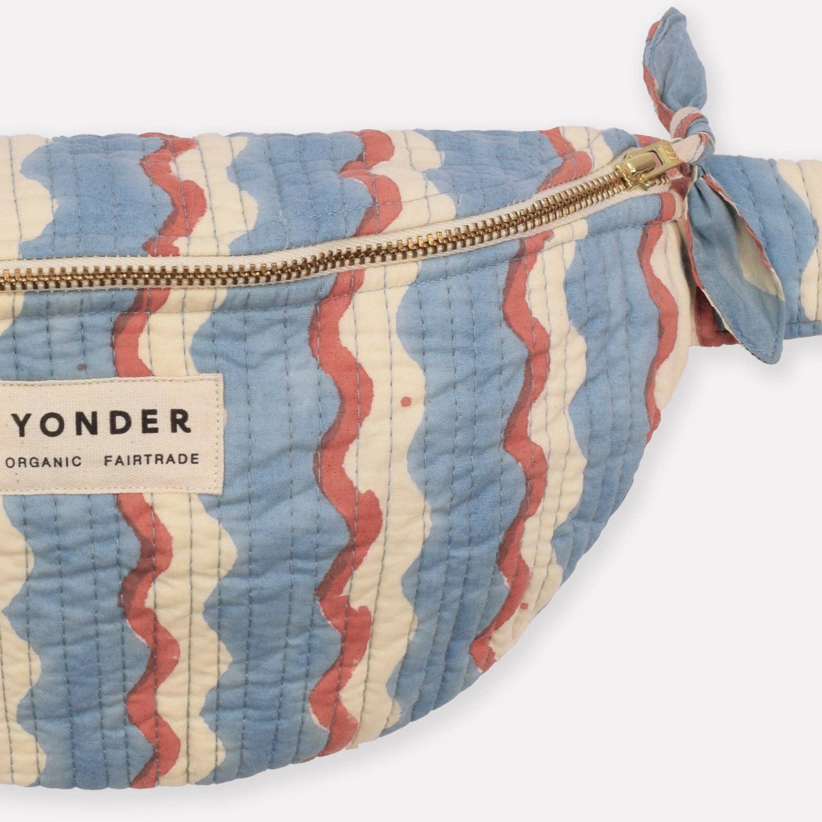 Patterned pouch with a visible brand label on a white background