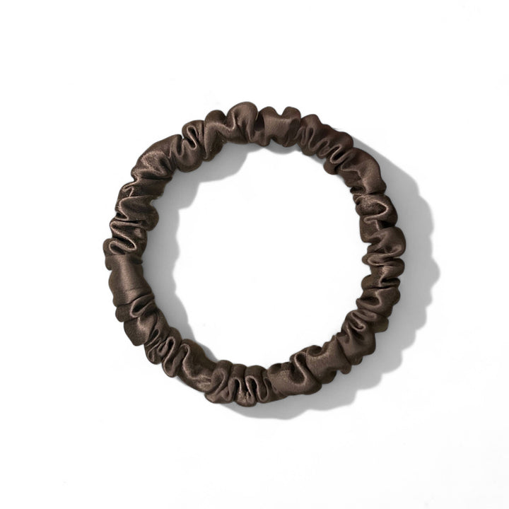 Brown silk scrunchie on a white background