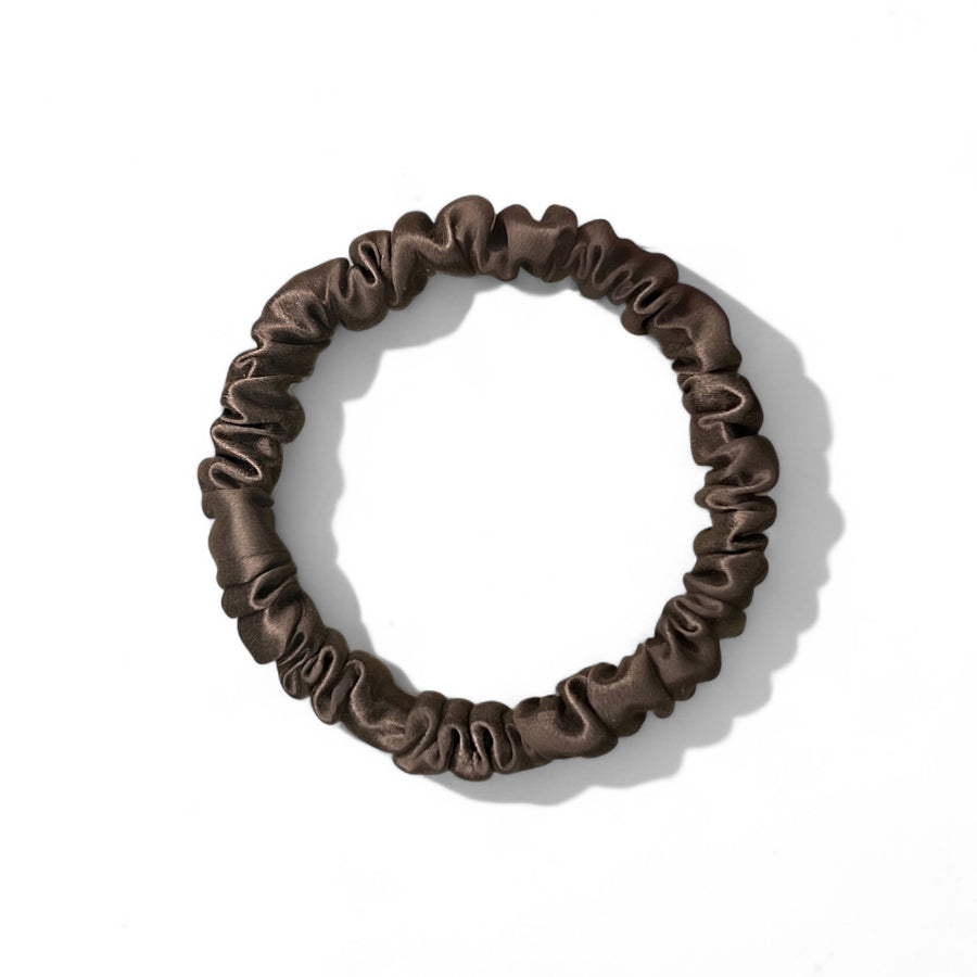 Brown silk scrunchie on a white background